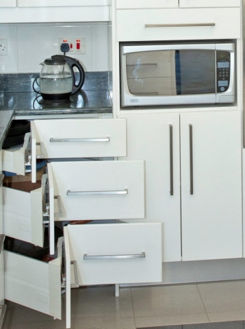 WHite painted gloss kitchen with Blum Intivo Tandembox Corner Drawer Mechanisms