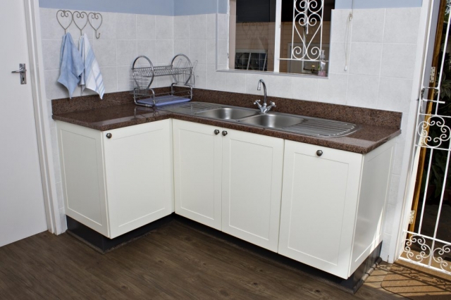 MDF white painted scullery with built in dustbin double sink & rose granite