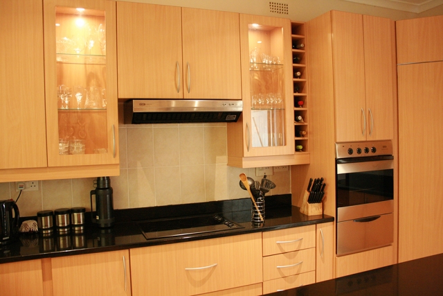 Beach Melamine kitchen with electric hob, eye level oven and glass units