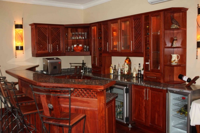 Natural Zimbabwean teak bar with raised panel doors and local Zimbabwean granite counter tops