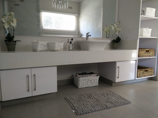 High gloss white vanity unit with white ceaserstone countertop